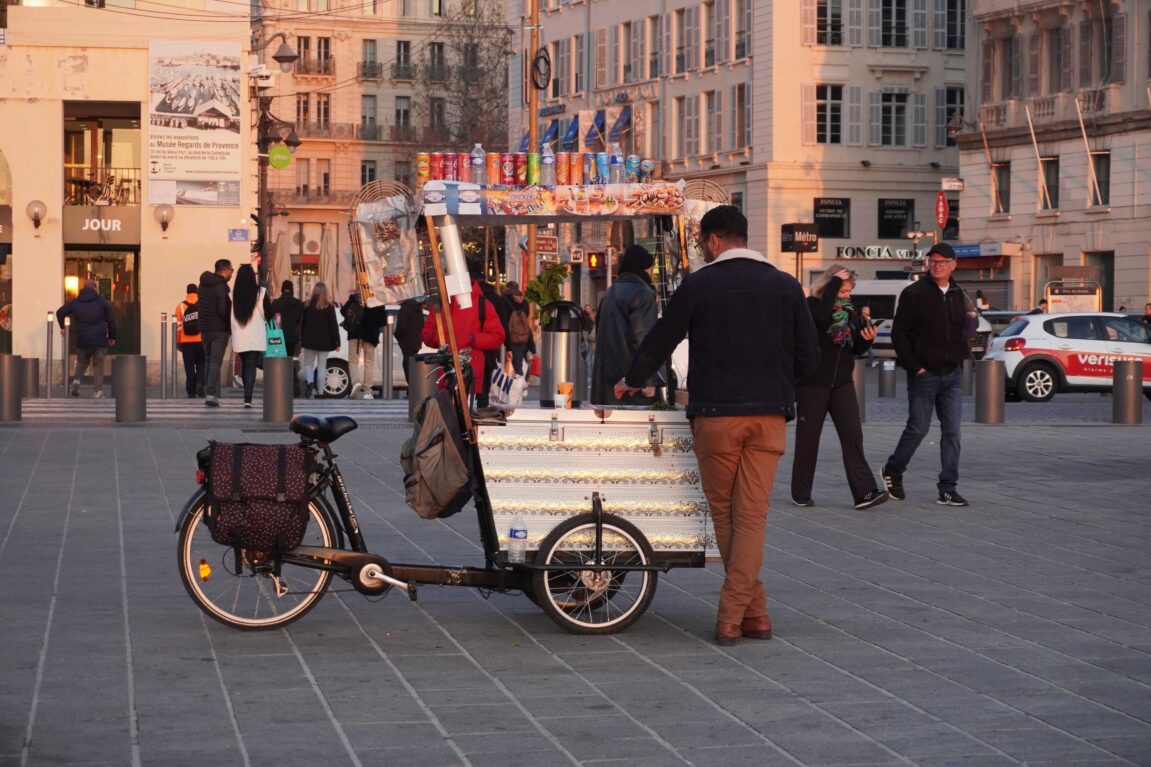 street vendor in a square with a cart